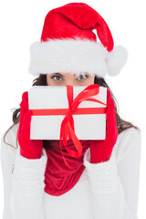 Brunette in red gloves and santa hat showing gift