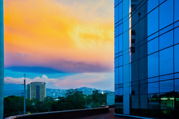 Dramatic sunset in Guatemala City, office space and finance in Central America, modern and avant-garde architectural design.