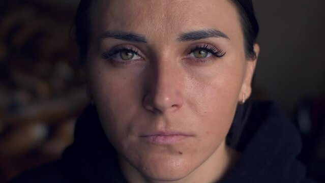 Portrait of Georgeous Millennial Woman. Serious girl open her beautiful green eyes and looking at camera. Slow Motion HD video
