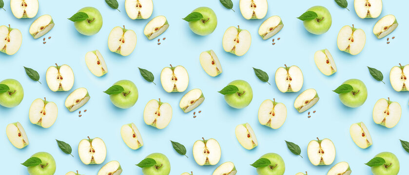 Many ripe apples on light blue background. Pattern for design