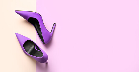 Pair of stylish high heeled shoes on color background with space for text