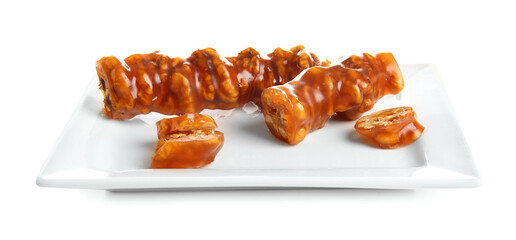 Plate with tasty churchkhela isolated on white background