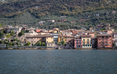 Fototapeta na wymiar View from height on roofs of italian resort Malcesine Garda Lake