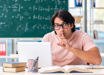 Young male student in the classroom