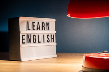 Learning English concept. Learn English message on white letter board. Language learning concept background.
