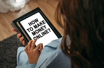 A woman holds a tablet in her hands on the screen of which it is written - How To Make Money Online