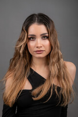 Fototapeta premium Close-up portrait of face of young beautiful model with long well-groomed hair and professional makeu. Beauty