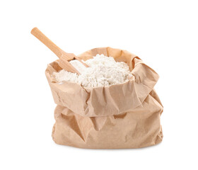 Paper bag with wheat flour and wooden scoop isolated on white background