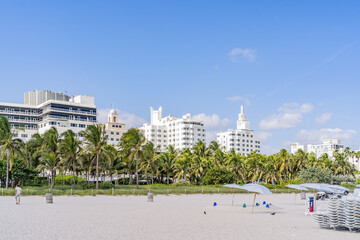 Miami Beach, USA - December 4, 2022. View of the sand of Miami Beach and the art deco buildings behind - 592054189
