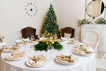 Beautiful table setting for Christmas or New Year dinner in the hall. Festive banquet.