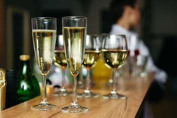 Glasses of champagne on a bar counter in a restaurant. Selective focus.
