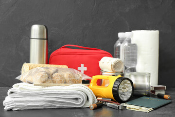 Necessities for emergency bag on dark table