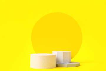 Decorative plaster podiums on yellow background