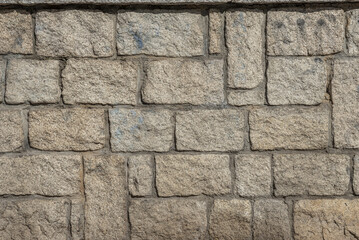 A wall of granite blocks with cement. vector background stone texture background