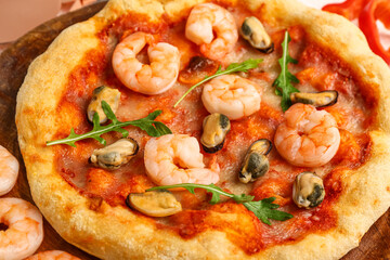 Plate with tasty seafood pizza on table, closeup