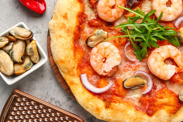 Tasty seafood pizza on grunge background, closeup