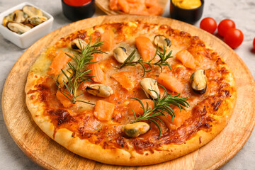Plate with tasty seafood pizza on grunge background
