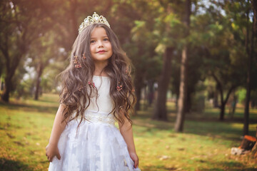 Girl in white dress, fairy tale princess, copy space, children's day theme.