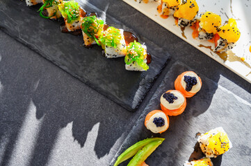 Obraz na płótnie Canvas Close up of tasty japanese uramaki sushi with salmon