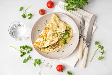 Tasty omelet with broccoli and mushrooms on light table
