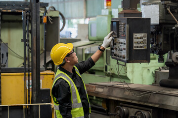 Staff or technicians are checking the operation of the old machine. Factory worker operation of the old machine via the remote.