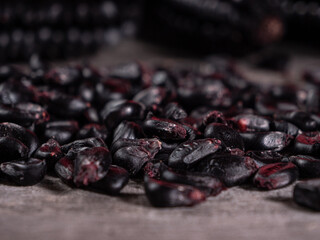 Detail of black corn kernels on rustic wooden table