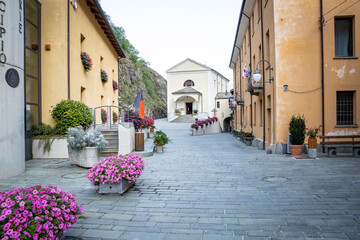 a street in Bard village with the church of Santa Maria Assunta in the middle, Aosta Valley, Italy