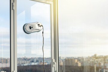 Smart vacuum cleaner washing windows. Technology concept.