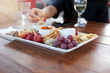 A plate of food on a table with a glass of sparkling wine on a summer afternoon