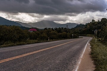 Sun setting on road overlooking mountains