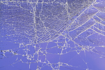 glass broken into a large number of pieces and cracks