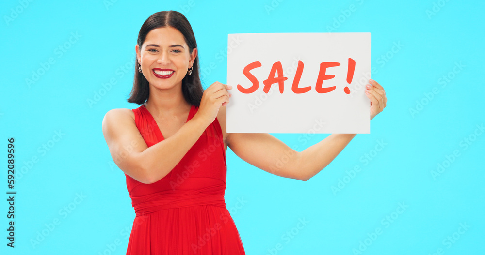 Wall mural Woman holding sale poster isolated on blue background for retail, shopping or customer discount announcement. Happy face of person with fashion promotion, deal or cardboard sign in studio advertising