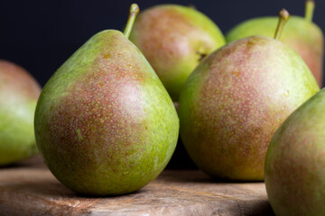 washed ripe green pears on the cutting board