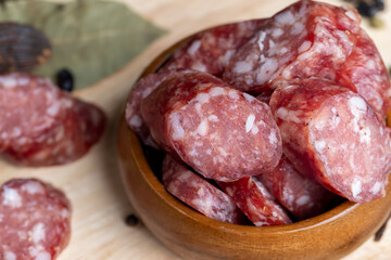 Dried veal sausage during slicing