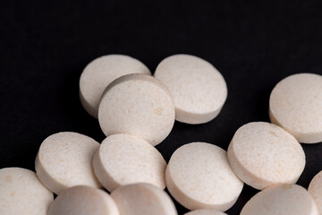 White and yellow medical medicines on a black background