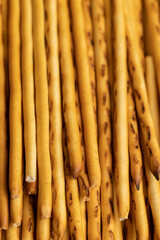 Thin and long bread sticks made of wheat flour on the table