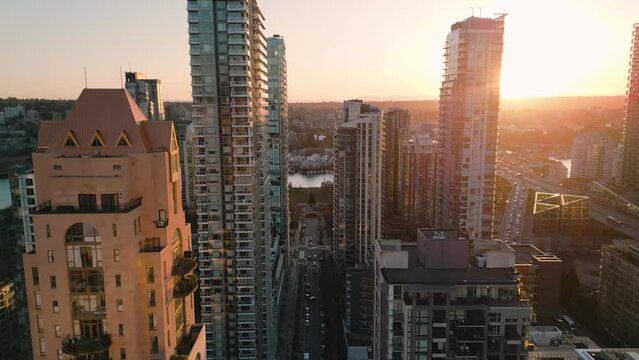 Flight along the street between skyscrapers at sunset. Vancouver, Canada.