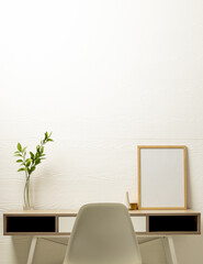 Vertical of empty wooden frame with copy space and plant in pot on desk against white wall