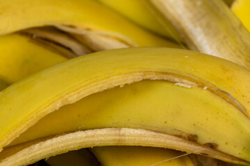 peeled ripe yellow bananas on a wooden board