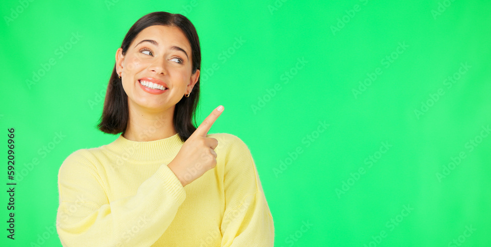 Poster Portrait, pointing and product placement with a woman on green screen in studio for marketing or advertising. Hand gesture, product placement and options with an attractive young female on chromakey