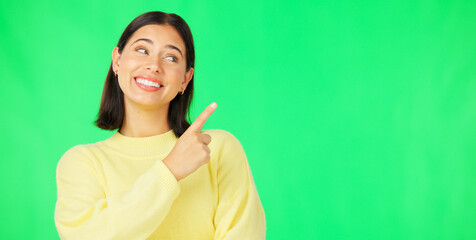 Portrait, pointing and product placement with a woman on green screen in studio for marketing or advertising. Hand gesture, product placement and options with an attractive young female on chromakey