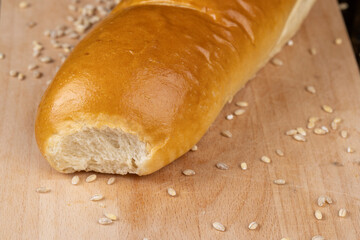 Wheat baguette on a wooden cutting board
