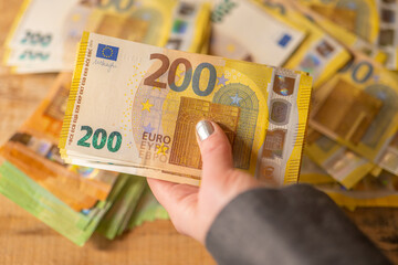  Recalculation of money.200 euro banknotes.Hands recalculate banknotes.Expenses and incomes in...