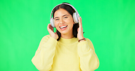 Face, green screen and woman with headphones, listen and movement on a studio background. Portrait, female dancer and person with headset, streaming music and excitement with stress relief and relax