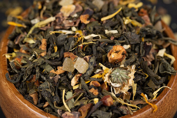 A large amount of dry green tea with pieces of fruit