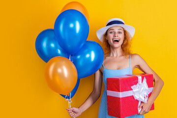 laughing birthday woman with present in studio. birthday woman with present