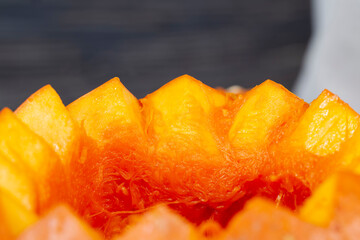 Sweet ripe orange pumpkin is sliced on the table