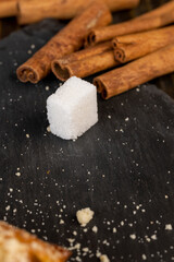 Refined sugar pieces on a black slate board