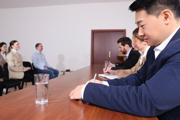 Business conference. People working at wooden table in meeting room
