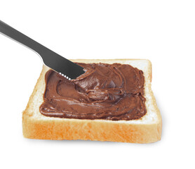 Spreading sweet chocolate paste onto toast on white background